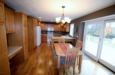 Kitchen & dining area w/ slider to deck
