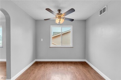 Unfurnished room featuring hardwood / wood-style flooring and ceiling fan
