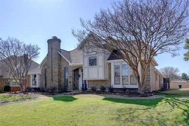 View of front of property with a chimney, brick si