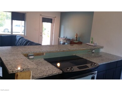 View from open kitchen to living room and front en