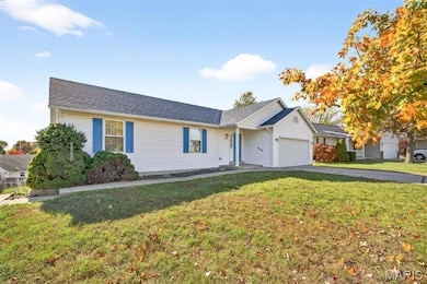Single story home featuring a front lawn, an attached garage, driveway, and roof with shingles
