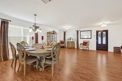 This spacious, well-lit dining/multi area features elegant wooden flooring and offers a welcoming entryway and ample space for entertaining.