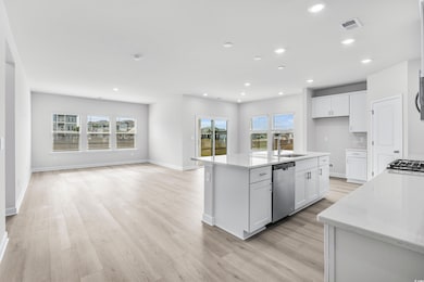 Kitchen featuring white cabinets, stainless steel 