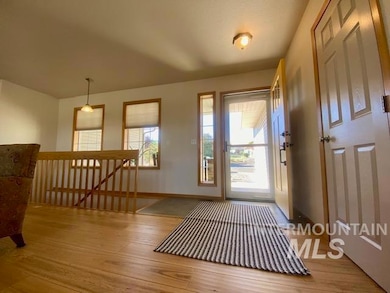 Entryway with light wood-style floors and baseboards
