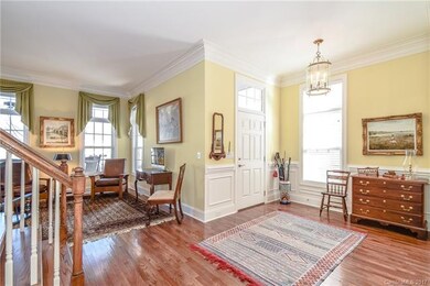 Large foyer area with wainscoting, beautiful moldi