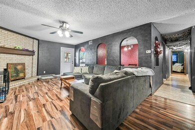 Living area featuring arched walkways, a fireplace