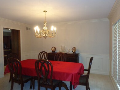 The formal dining room has wainscoting, chair rail