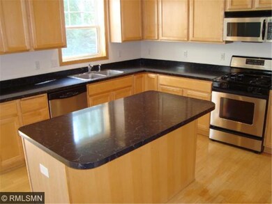 Spacious open kitchen with center island and hardw