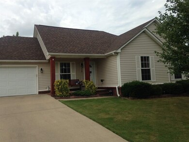 Walk up to this inviting porch and well landscaped