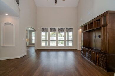 Your huge family/living area is big on its amazing vaulted ceiling, recessed wall shelves, a gorgeous, walnut colored wood floor; and wall and floor space, galore!