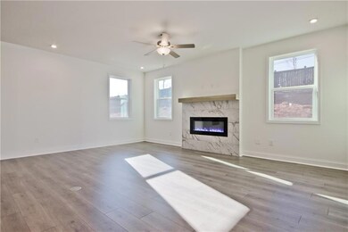 Unfurnished living room featuring wood finished fl