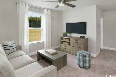 Living area featuring a ceiling fan, baseboards, a
