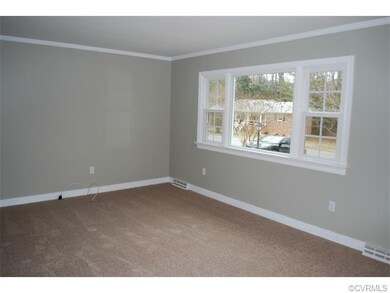 Living room features large picture window, crown m