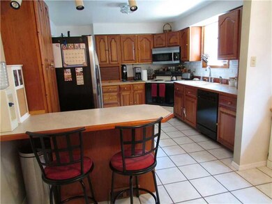 Kitchen. Custom cabinetry, island with stools. Che
