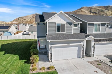 View of front of home featuring a mountain view, a shingled roof, concrete driveway, and a garage