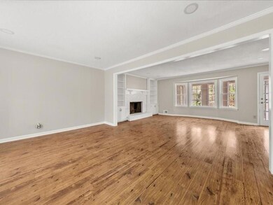 Unfurnished living room with ornamental molding, b