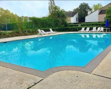 This photo features a spacious outdoor swimming po