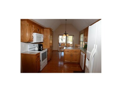 Kitchen with vaulted ceiling, country dining area.
