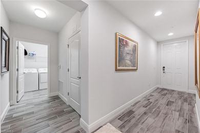 Hallway featuring washing machine and clothes drye