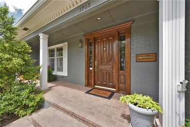 Inviting covered front brick entry.
