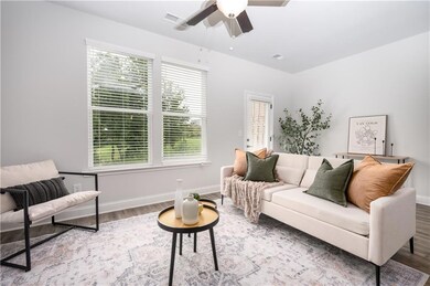 Living room with wood finished floors and ceiling fan