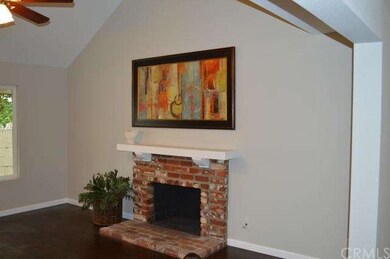 Brick fireplace in living room with vaulted ceilin