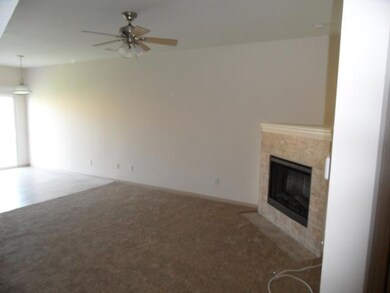 Spacious living room with electric fireplace.