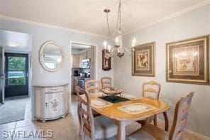 Dining area with tile patterned floors, crown mold