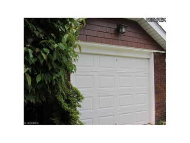 The brick one car garage is adorable.