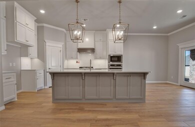 Kitchen with pendant lighting, backsplash, stainle
