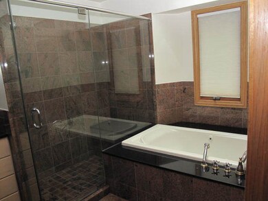 Ultra bath has oversize shower and whirlpool tub