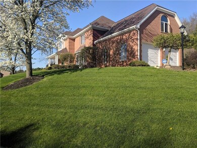 Side lot view shows all brick 2 -story home. Above