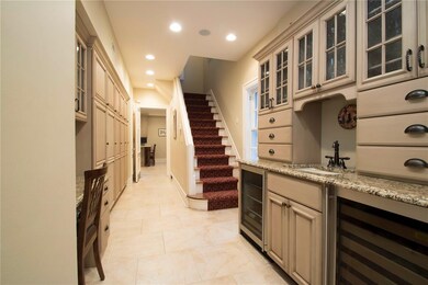 Kitchen featuring wood paneled commercial style refrigerator/freezer, stainless built in microwave, and storage galore!