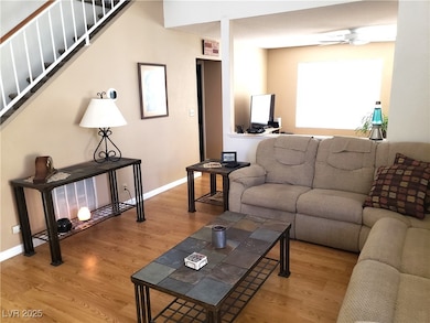 Living room with wood finished floors, a ceiling f