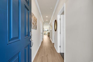 Hallway featuring light wood finished floors, rece