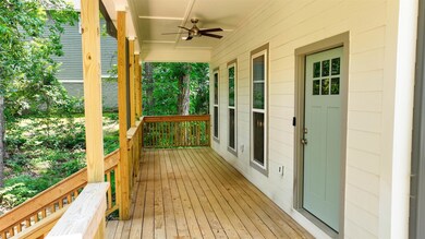 Wooden porch featuring a ceiling fan