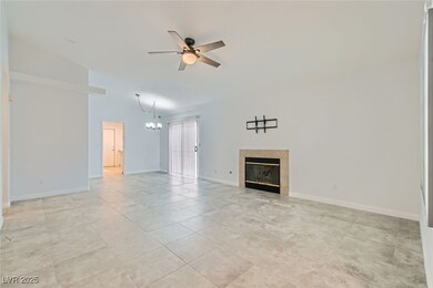 Unfurnished living room with ceiling fan, a tile f