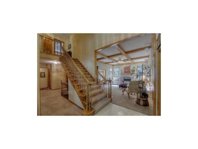 View into great room and hall to powder room and k