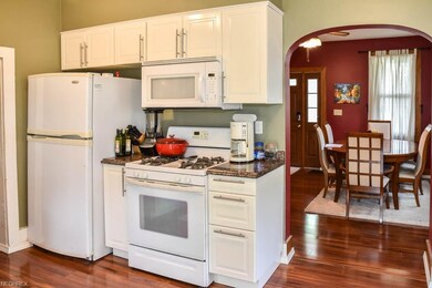 An arched doorway leads from the dining room to th