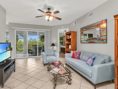 Tiled living room featuring ceiling fan