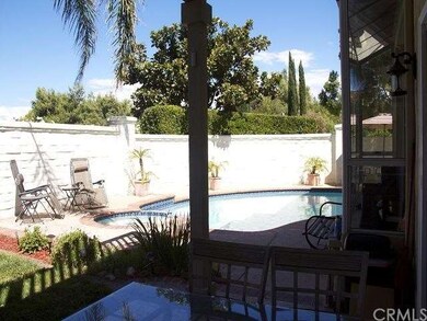 Taken from under covered area of patio toward pool