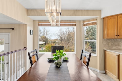 Dining space with healthy amount of natural light and a chandelier