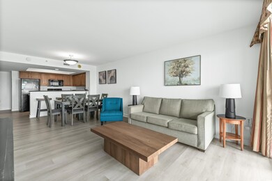 Living room with light hardwood / wood-style floor
