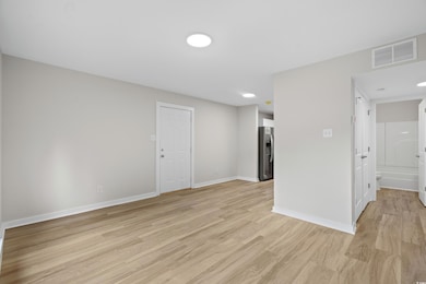 Unfurnished room with light wood finished floors a