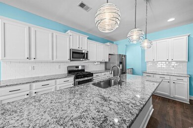Kitchen featuring light stone countertops, pendant