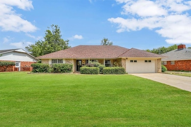 Ranch-style house with a front lawn and a garage