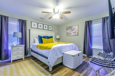 Bedroom featuring ceiling fan and dark hardwood / 