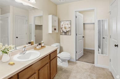 Bathroom featuring vanity and a walk-in shower, linen closet and walk-in closet