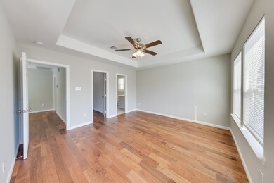 The master bedroom is a spacious retreat, complete