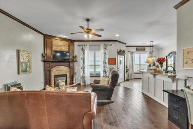 vaulted ceiling, ceiling fan, crown molding, hardw
